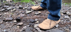Black Jacket Moccasins outdoors on riverbed in woods