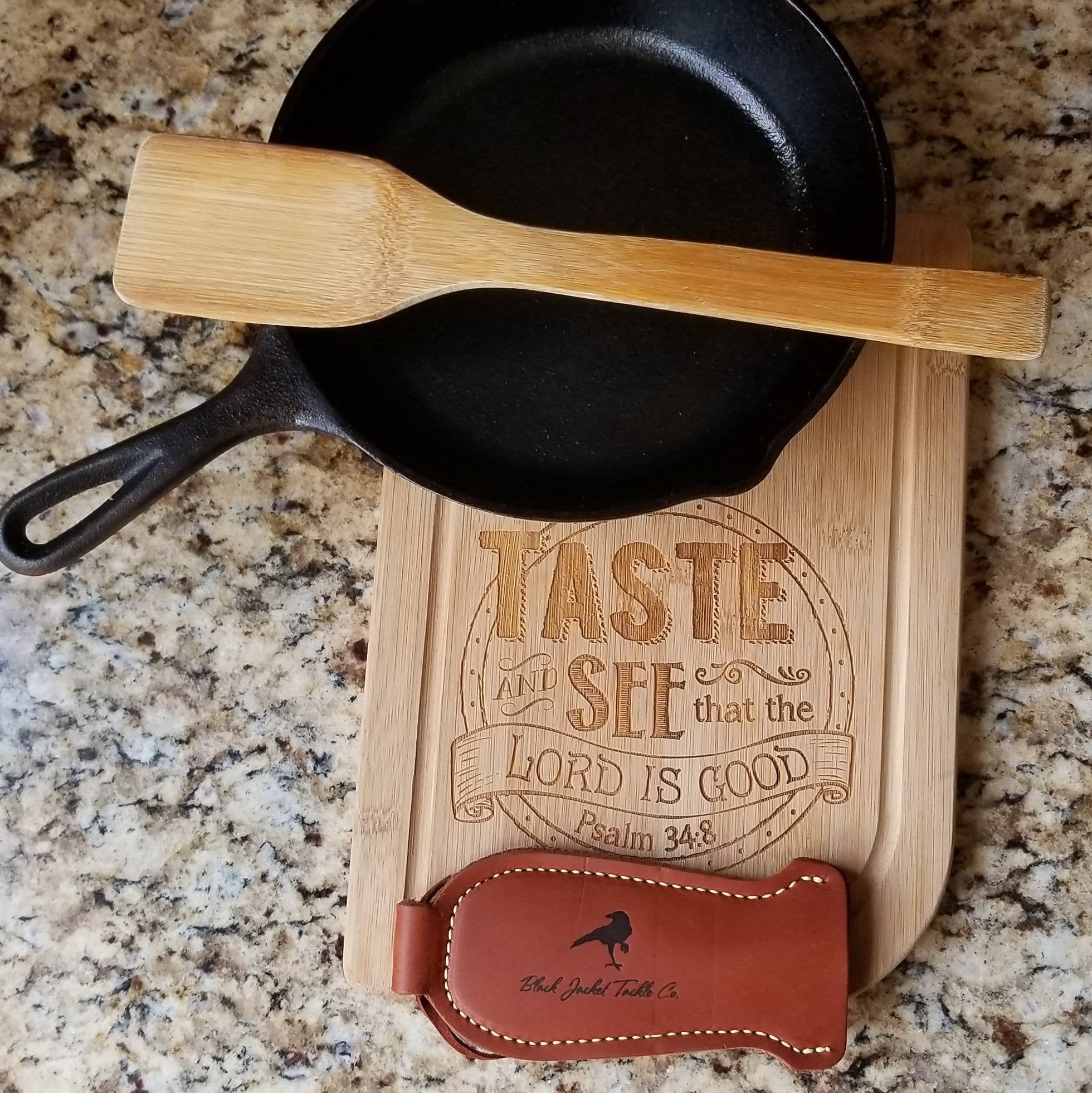 Standard pan handle holder shown with cast iron skillet, wooden spoon and wood cutting board